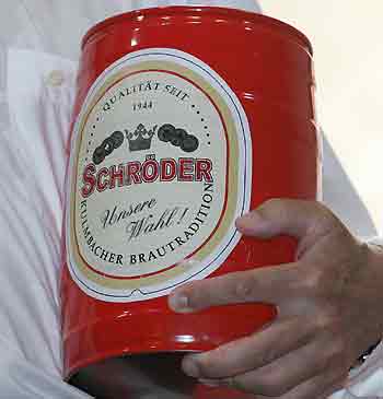 Germany's Chancellor Gerhard Schroeder holds a beer barrel called 'Schroeder' during an election campaign rally for Germany's Social Democratic Party (SPD) in the southern German town of Kulmbach September 7, 2005. [Reuters]