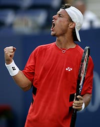 Lleyton Hewitt of Australia celebrates a point in his last set against Jarkko Nieminen of Finland in their quarterfinal match at the U.S. Open tennis tournament in Flushing Meadows, New York September 8, 2005. 