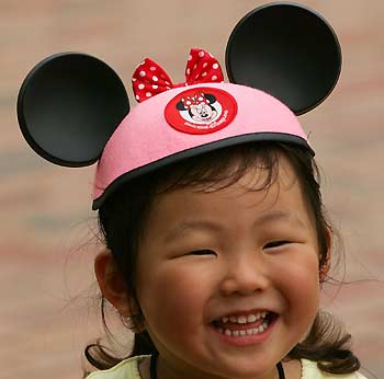 A young guest smiles at Hong Kong Disneyland September 11, 2005, a day before its official opening. [Reuters]
