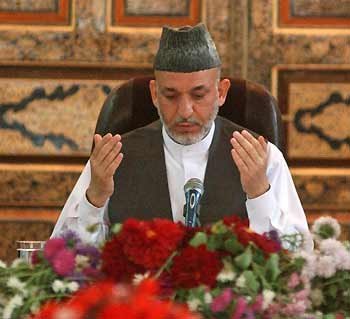 Afghanistan's President Hamid Karzai prays before a meeting with civil society representatives as part of the campaign for the forthcoming parliamentary elections, in the western Afghan city of Herat September 13, 2005. Afghanistan's foreign backers should not see Sunday's elections as a signal to disengage but rather to increase support until the country can stand on its own feet, the president said on Tuesday. [Reuters]