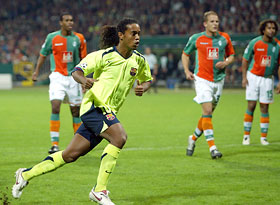 FC Barcelona's Brazilian Ronaldinho of Brazil (2nd L) celebrates a goal, as Werder Bremen's Nando(L), Petri Pasanen and Patrik Owomoyela (R) look on, during their Champions League Group C soccer match in Bremen September 14, 2005.