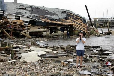 Jack Borinski, of Richmond, Va., videotapes the damage caused by Hurricane Ophelia in Salter Path, N.C., Thursday, Sept. 15, 2005.