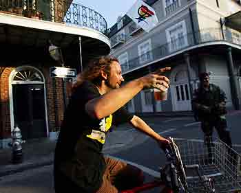 A man rides a bike with a glass of beer in his hand at the French Quarter in New Orleans September 15, 2005. New Orleans took a big step towards recovery from Hurricane Katrina on Thursday, when its mayor declared parts of the city would reopen at the weekend, as U.S. President George W. Bush prepared to announce a major rebuilding operation for the devastated Gulf region. [Reuters]