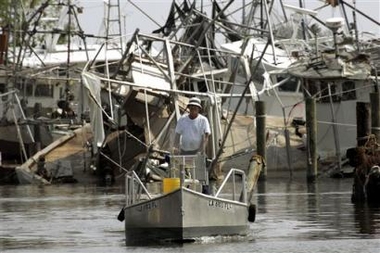 John Mioc searches for his commercial fishing boat in the Empire, La., harbor Monday, Sept. 19, 2005. Many commercial fishing boats sustained damage by Hurricane Katrina nearly three weeks ago. (AP