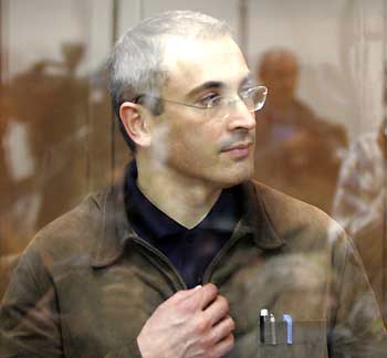 Oil tycoon Mikhail Khodorkovsky looks on as he stands in a glass cage in Moscow City Court before the court's verdict on his appeal against his fraud conviction, September 22, 2005. A Moscow court on Thursday threw out an appeal by Khodorkovsky against his conviction, but reduced his nine-year jail sentence to eight years. [Reuters]