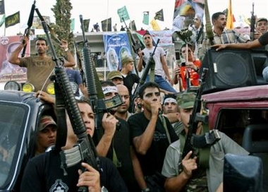 Palestinians celebrate the evacuation of the Dotan Israeli military base south of the West Bank town of Jenin Thursday Sept. 22, 2005.