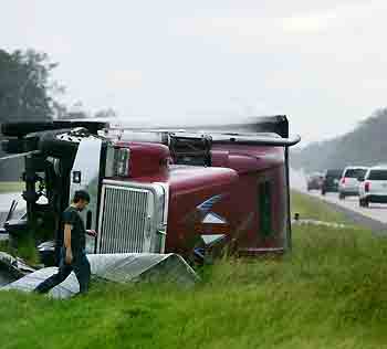 A truck lies on its side on I-10 highway in Orange, Texas in the aftermath of Hurricane Rita September 24, 2005. 