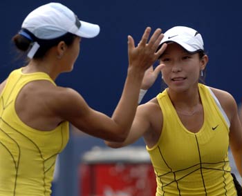 Zheng Jie (R) and Yan Zi of China celebrate a point during their China Open finals against Nuria Llagostera Vives of Spain and Maria Vento-Kabchi of Venezuela in Beijing September 25, 2005. [Xinhua]