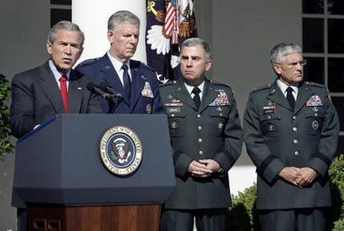 U.S. President George W. Bush makes a statement on the 'War on Terror' in the Rose Garden of the White House in Washington September 28, 2005, alongside (2nd L-R) Chairman of the Joint Chiefs of Staff General Richard Myers, Army General John Abizaid and Army General George Casey.