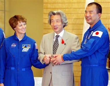 Space Shuttle STS-114 crew, U.S. commander Eileen Collins, left, and Japanese specialist Soichi Noguchi, right, shake hands with Prime Minister Junichiro Koizumi at Koizumi's official residence in Tokyo Monday, Oct. 3, 2005.