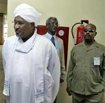 Majzoub Al-Khalifa, Sudanese Agriculture minister and head of a Sudanese government delegation, left, walks into the venue of the Darfur peace talks in Abuja, Nigeria, Monday, Oct. 3 2005.