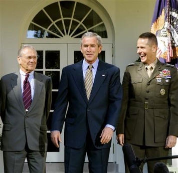 President Bush, center, steps outside of the Oval Office at the White House with Defense Secretary Donald H. Rumsfeld, left, and Marine Gen. Peter Pace, the new Joint Chiefs chairman, to talk to reporters about the status of Iraq's constitutional referendum, Wednesday, Oct. 5, 2005, in Washington. (AP 