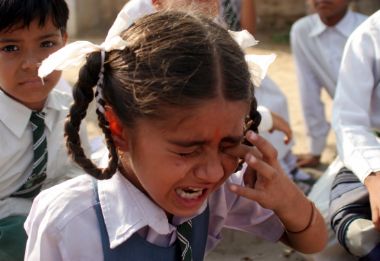An Indian student cries outside a school building following an earthquake in the northern Indian city of Jammu, October 8, 2005.