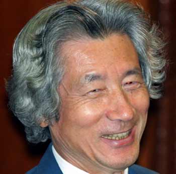 Japanese Prime Minister Junichiro Koizumi smiles during the Lower House plenary session at the parliament in Tokyo October 11, 2005. Bills to privatise Japan's postal system, including the world's largest savings bank, were passed by parliament's lower house on Tuesday, setting the stage for Koizumi to achieve the core of his reform agenda.