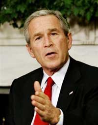 President Bush takes questions from reporters during his meeting with Polish President Aleksander Kwasniewski in the Oval Office in Washington, Wednesday, Oct. 12, 2005. (AP