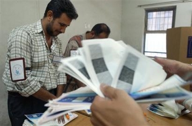 Iraqi referendum officials count votes in Baghdad, Iraq, Saturday Oct. 15 2005.