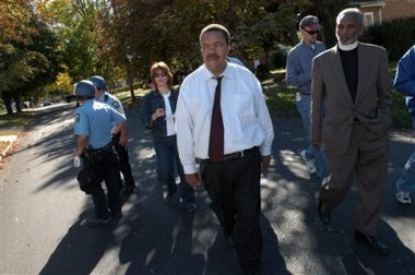 Toledo, Ohio Mayor Jack Ford, center, is seen after trying to plead with a group of protestors, Saturday, Oct. 15, 2005, in Toledo, Ohio.