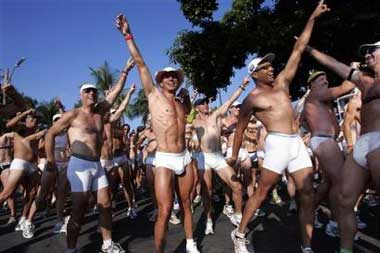 Competitors wearing little but their underwear laugh as they briefly strike an 'Ironman' pose during a break for stretching during the ninth annual Underpants Run, Thursday, Oct. 13, 2005, in Kailua-Kona, Hawaii. About 100 men, women and children ran in the mile-long event, which crossed paths with the start and finish areas of the considerably more serious Ironman competition, which will be held Saturday. The Underpants Run, originally begun to poke fun at Speedo-wearing Ironman competitors, is now a fundraiser for a local charity.