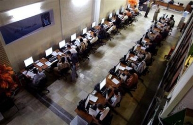 Election employees enter data from yesterday's constitution referendum at the headquarters of the Independent Electoral Commission in Iraq (IECI) in Baghdad, Iraq, Sunday Oct. 16 2005.