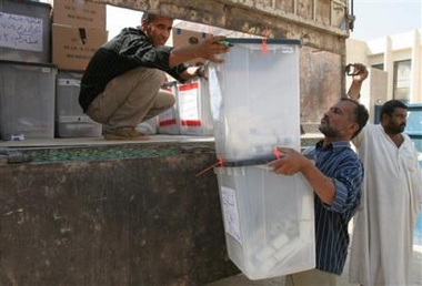 Iraqi electoral workers load ballot boxes on a truck before sending them to be counted in Baghdad, Iraq, Monday, Oct. 17 2005.