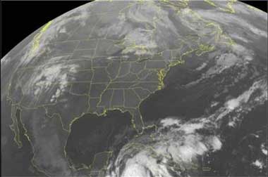 This NOAA satellite image taken Wednesday, Oct. 19, 2005, at 2:15 a.m. EDT shows thick clouds associated with Hurricane Wilma centered west-southwest of Jamaica. The storm is expected to remain a strong hurricane the next few days while moving north-northwest through the Yucatan Channel. Over land, low clouds can be seen over parts of the Northeast, but few clouds can be seen over the Southeast. The extreme northern portion of Michigan is experiencing light showers from clouds over the region, while thunderstorms are making their way into the Southern Plains. (AP