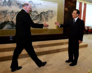 U.S. Treasury Secretary John Snow, left, shakes hands with Chinese Premier Wen Jiabao during their meeting in Beijing Monday, Oct. 17, 2005. [AP] 