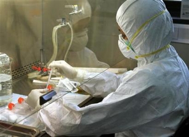 A scientist isolates influenza virus cells at the World Health Organization National Influenza Center in Bangkok on October 21, 2005.