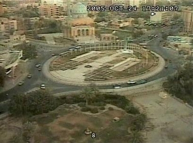 An image taken from a security camera shows a white vehicle on the roundabout outside the cement wall surrounding the Palestine Hotel compound, bottom right, moments before it appears to explode near the Palestine hotel in Baghdad, Iraq, Monday, Oct. 24, 2005.