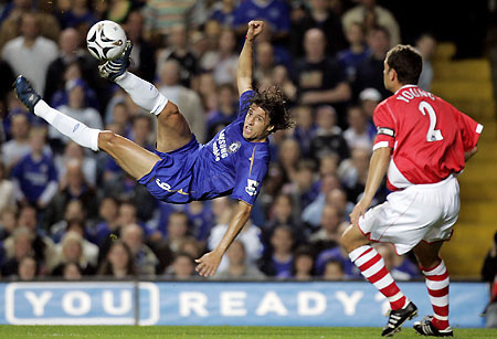Chelsea's Hernan Crespo (L) takes a shot on goal as Charlton Athletic's Luke Young looks on during their English League Cup third round soccer match at Stamford Bridge in London October 26, 2005.