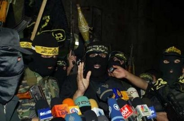 Palestinian gunmen from four armed factions, including the Islamic Jihad, speak during a news conference in Gaza October 26, 2005. 