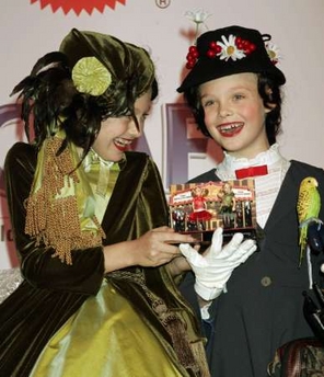 Actresses Dakota (L) and her sister Elle Fanning hold a set one-of-a-kind Polly Pocket dolls in their likeness which they received at the 12th annual Dream Halloween fundraiser sponsored by the Children Affected by AIDS Foundation in Santa Monica October 29, 2005. Dakota and Elle donated the dolls which were then auctioned off at the event to raise funds for the care of children affected by AIDS.