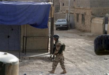 In this picture released Sunday, Nov. 6, 2005, by the US Marine Corps, an Iraqi Army soldier patrols the streets of Husaybah, Iraq, Sunday, Nov. 6, 2005, after clearing this section of town of insurgents during Operation Steel Curtain. 