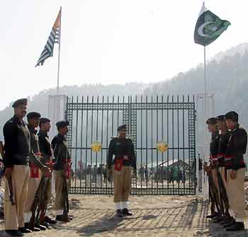 Pakistani guards of honour line up in front of the gate of the Line of Control (LoC) in Titrinote, Pakistan-administered Kashmir, about 180-km (111.8 miles) east of Islamabad, November 7, 2005 in preparation for the opening of the LoC.