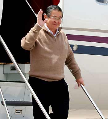 Former Peruvian president Alberto Fujimori waves upon his arrival from Tokyo to Santiago de Chile November 6, 2005.