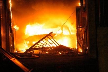 A car blazes after it was used to smash in the main gate of the nursery school 'Maternelle du Lac' in the La Reynerie housing project in the Mirail district of Toulouse, southwestern France, Wednesday, Nov. 9, 2005.