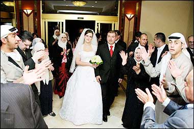Ashraf Mohamed al-Akhras and his bride Nadia al-Alami arrive at Radisson SAS hotel's Philadelphia hall at the start of their wedding party before an explosion hit the hotel in the heart of Amman. The bride and the groom both lost their fathers to the deadly blast that ripped through their wedding reception at the luxury hotel. The couple were also wounded in the explosion. 'I lost my father and my father-in-law and I saw many other dead. This is a horrible crime. The world has to know this has nothing to do with Islam,' Khaled told state television from his hospital bed.(AFP) 