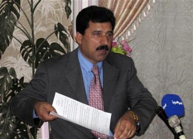 Khalil al-Dulaimi, chief lawyer for Iraq's former president Saddam Hussein, holds a letter indicating that he will stop all dealings with the tribunal trying Hussein, during an interview in Ramadi November 9, 2005.