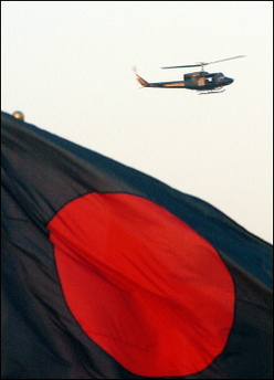A Bangladeshi Rapid Action Batallion (RAB) helicopter hovers over the country's flag as leaders arrive for the 13th South Asian Association for Regional Cooperations (SAARC) summit at Zia International Airport, Dhaka.