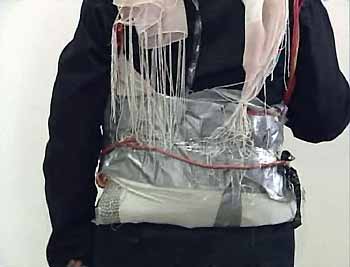 A video grab image shows Sajida al-Rishawi who confessed on Jordanian TV to trying to blow herself up at a hotel in Amman, showing how she strapped a device to her body, November 13, 2005.