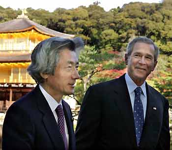 U.S. President George W. Bush (R) smiles as he walks with Japanese Prime Minister Junichiro Koizumi during a morning visit to Kinkakuji Temple, also known as the Golden Pavilion, ahead of their talks in the ancient Japanese capital of Kyoto November 16, 2005. Bush is meeting with Koizumi in Japan on the first stop of a week-long Asian tour.