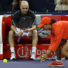  Andre Agassi rests during a match with Russian Nikolay Davydenkov at the Tennis Masters Cup in Shanghai, China November 14, 2005.