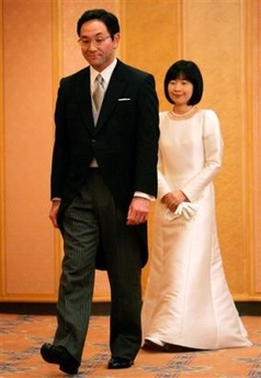 Sayako Kuroda follows her husband Yoshiki Kuroda upon their arrival at a press conference following their wedding ceremony at a Tokyo hotel Tuesday , Nov. 15, 2005.