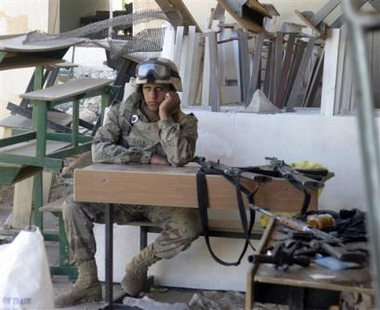 In this picture released by the US Marine Corps, Monday, Nov. 14, 2005, an Iraqi Army soldier relaxes after locating a weapons cache in a school allegedly occupied by insurgent forces, in Karabilah, Iraq, Friday, Nov. 11, 2005. 