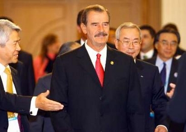 Mexico's President Vincente Fox (C) arrives at a breakfast meeting of the Asia-Pacific Economic Cooperation (APEC) CEO summit in Pusan, South Korea, November 18, 2005.