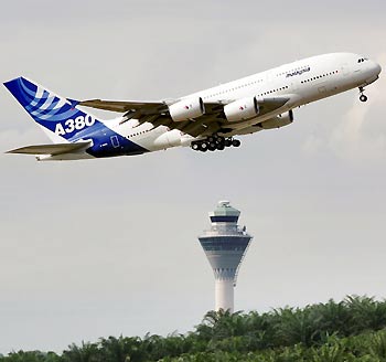 An Airbus A380 takes off past the control tower of Kuala Lumpur International Airport in Sepang November 18, 2005. The world's biggest airliner, the European Airbus A380, touched down in Kuala Lumpur on Wednesday, completing its first flight to Asia -- the most competitive market for plane manufacturer Airbus and its U.S. rival Boeing.