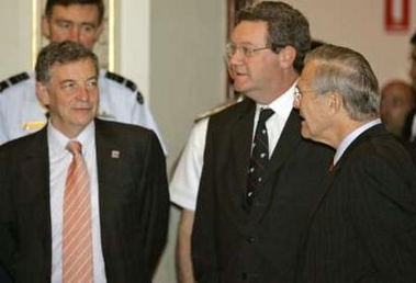 .S. Defense Secretary Donald Rumsfeld (R) speaks to Australia's Defense Minister Robert Hill (L) and Foreign Minister Alex Downer before the Australia-U.S. Ministerial Consultations in Adelaide, Australia November 18, 2005. 