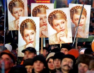 Ukrainian demonstrators hold a portraits of sacked Prime Minister Yulia Tymoshenko during a rally at the Indepedence Square in Kiev, November 22, 2005. 