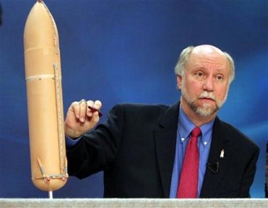 NASA's John Chapman, manager of the external tank program, points to problem areas on a model of a space shuttle rocket during a news conference Tuesday, Nov. 22, 2005, at Johnson Space Center in Houston.