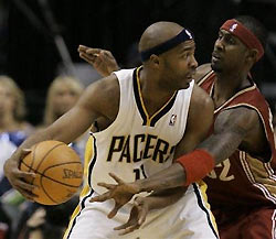 Indiana Pacers' Jamaal Tinsley, left, is defended by Cleveland Cavaliers' Larry Hughes during the second quarter in Indianapolis, Thursday, Nov. 24, 2005.
