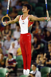 Hiroyuki Tomita of Japan competes in the rings event during the men's all around final at the World Gymnastics Championships at Rod Laver Arena in Melbourne November 24, 2005. 